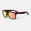 Angled view of the Quiksilver Classic Square sunglasses, highlighting the black frame, red zebra pattern temples, and the vibrant orange mirror lens on an Accessory Studio display.