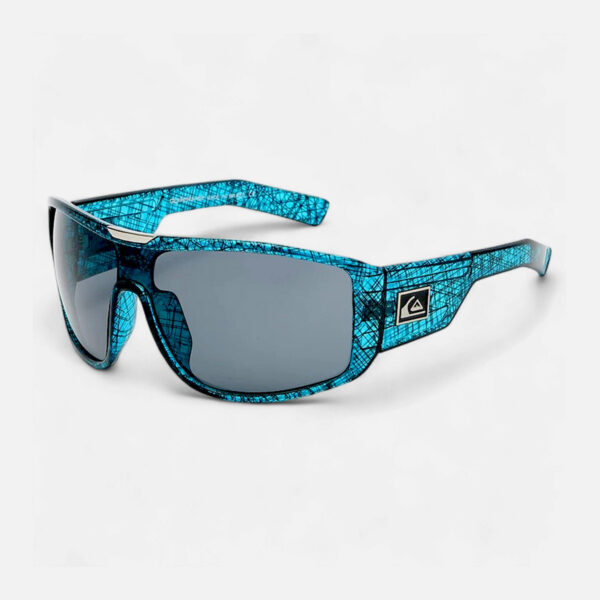 Angled view of the Quiksilver QS236 Polarized Sport Wrap Shield sunglasses, showing the unique blue crosshatch pattern frame and the dark smoke polarized shield lens.