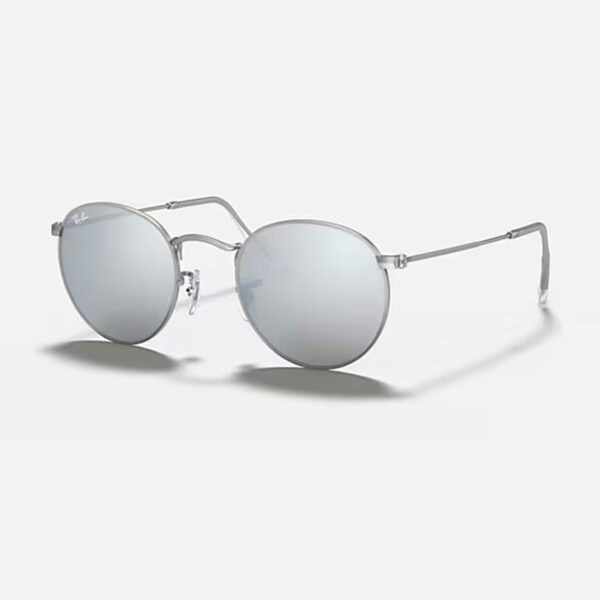 Left angled view of the Ray-Ban Round Metal RB3447 sunglasses, showing the thin matte silver metal frame and the bright silver flash circular lenses.