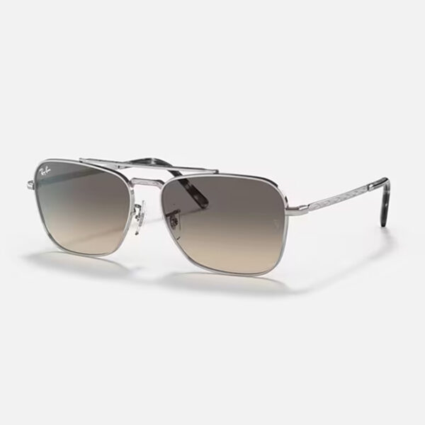 Angled view of the Ray-Ban New Caravan RB3636 sunglasses, highlighting the sleek silver metal frame and the grey gradient squared lenses.