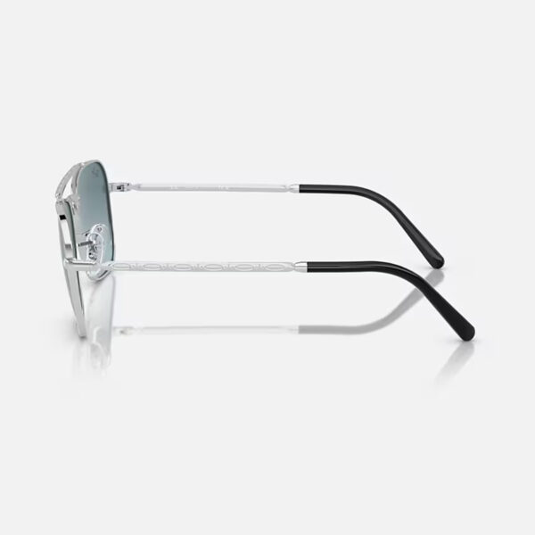 Ray-Ban RB3636 New Caravan sunglasses in silver with light blue gradient lenses, left side view highlighting frame and temple design.
