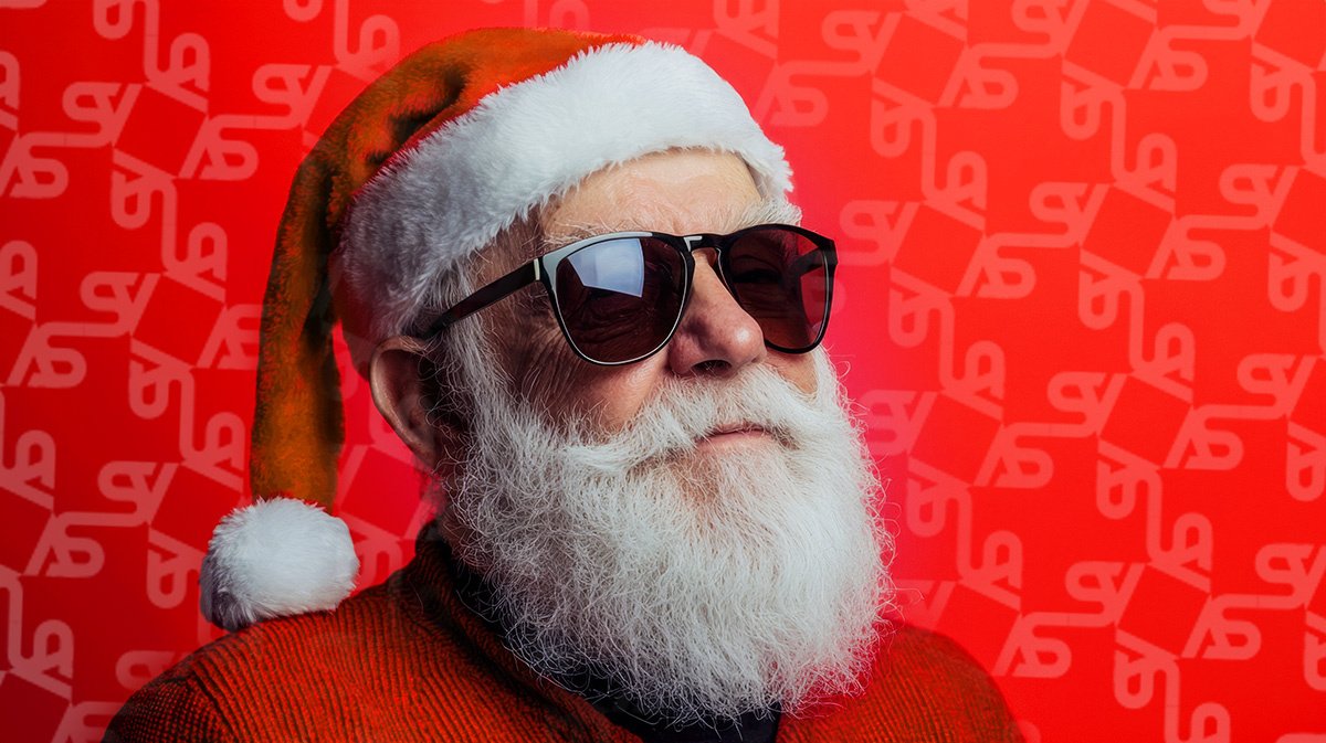 Santa wearing sunglasses and a santa hat. The Accessory studio repeating pattern is show on a red background.